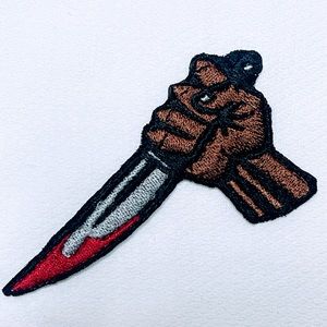 A man with a bloody knife iron on patch